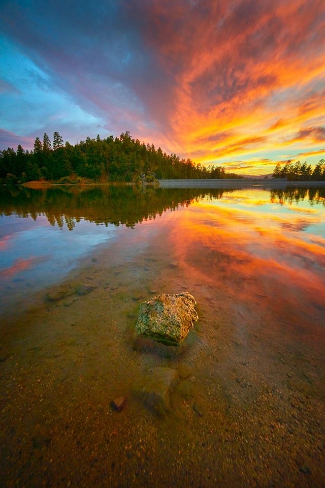 Vibrant sunset over a calm lake.