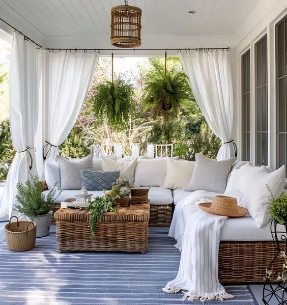 Cozy patio with wicker furniture and plants.