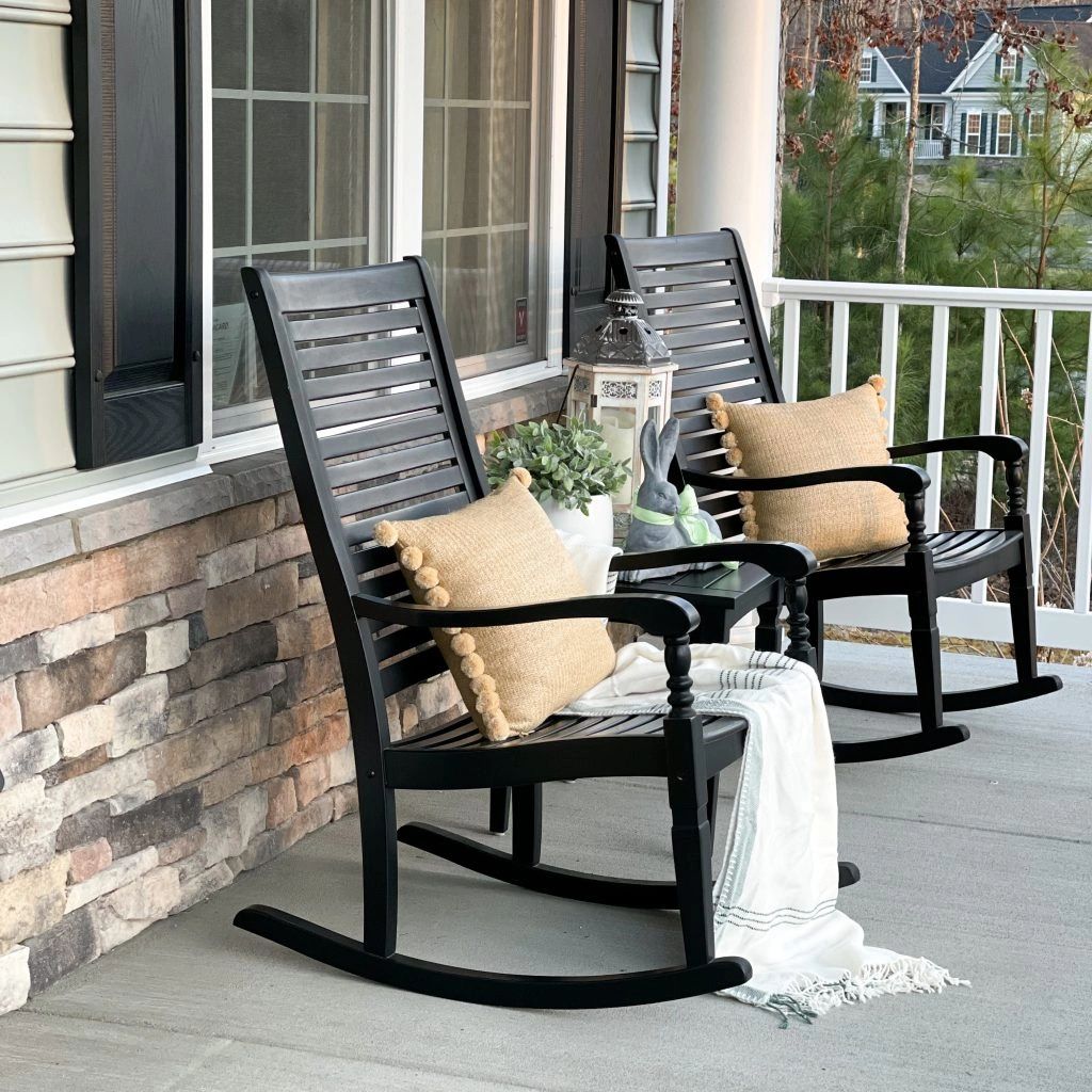 Two rocking chairs on a cozy porch.