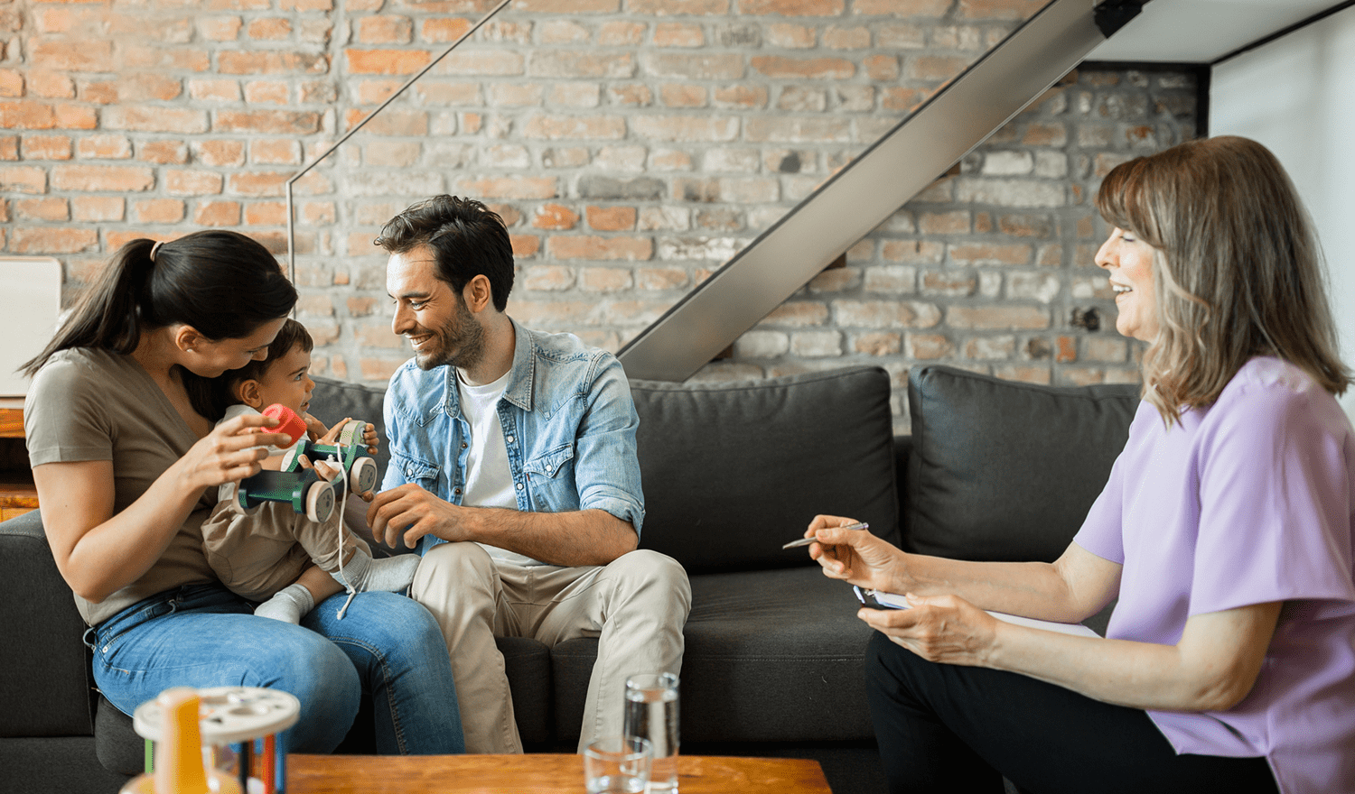 Parents with baby talking to therapist